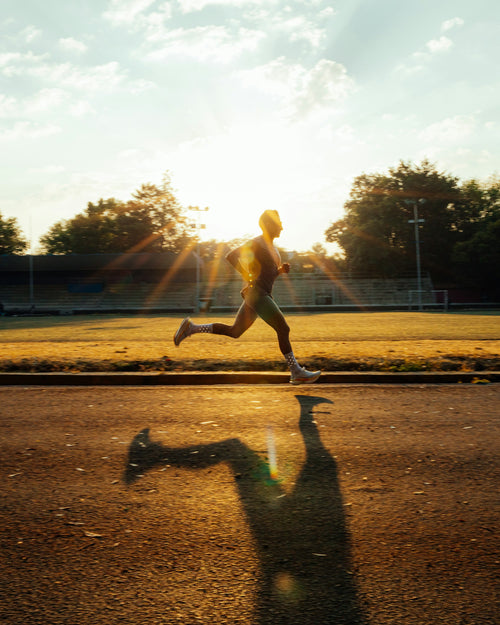 Sprinter on the track in golden light – Aurivo Athlete